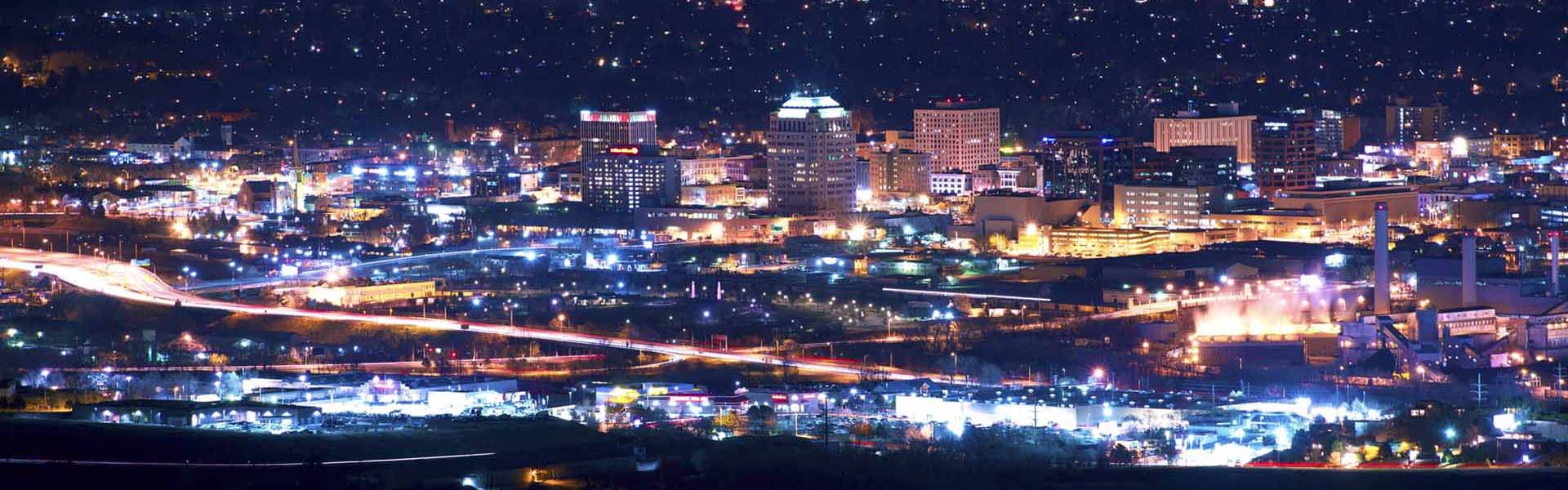 Neon color image of a band playing and people singing along